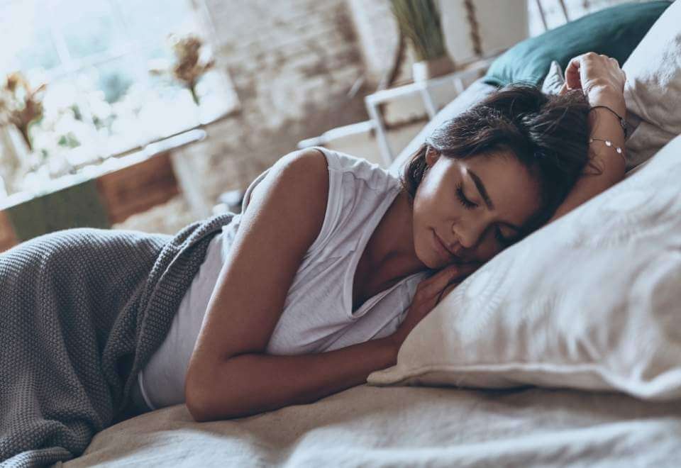 Brunette woman sleeping in bed