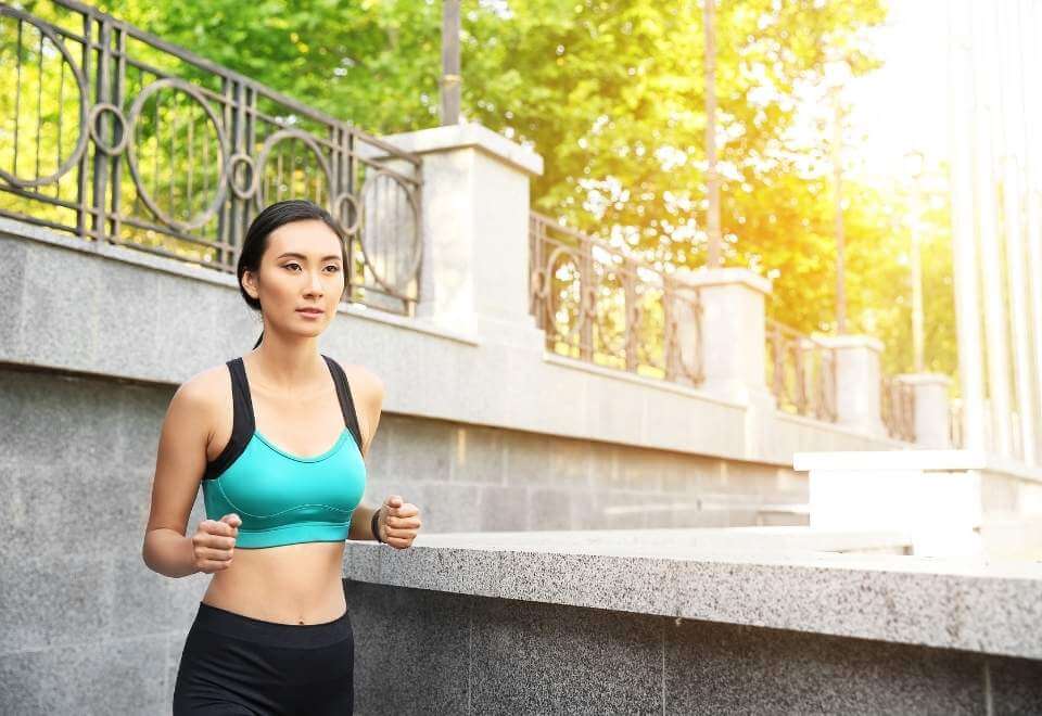 Woman running in sunlight