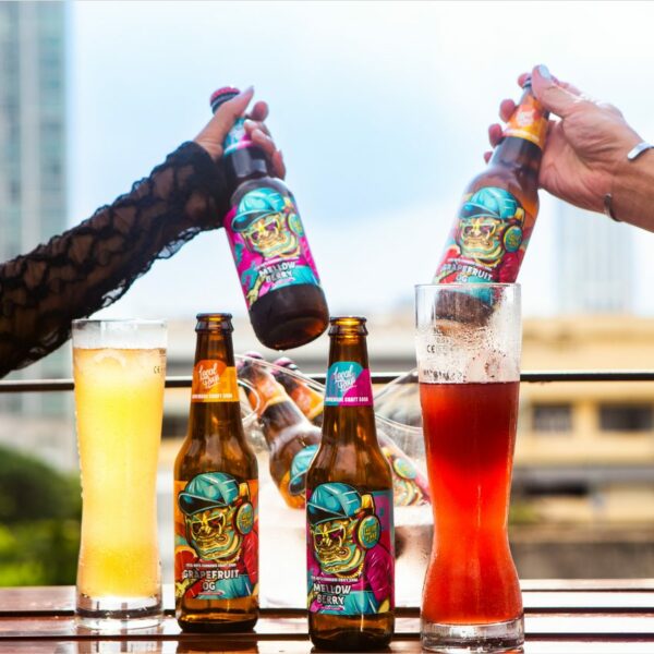 Local Boys THC Craft Soda - Mellow Berry Flavor product photo group shot with both flavors on table with hands cheering.